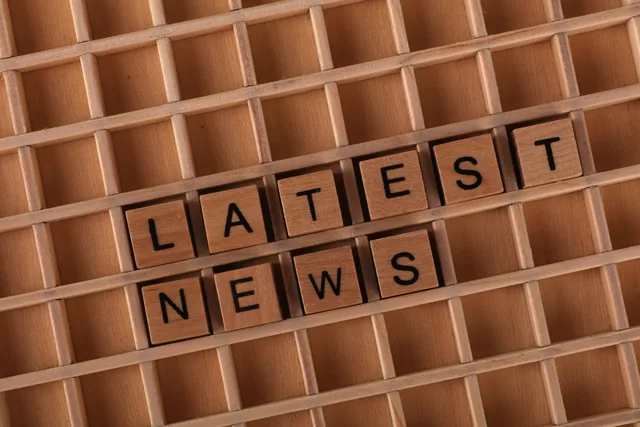 Wooden letter blocks spelling 'Latest News' on a grid surface. Ideal for media concepts. Press release distribution strategy mistakes: accessible formats before send